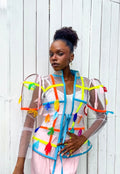 Person wearing a colorful, transparent jacket with a white background